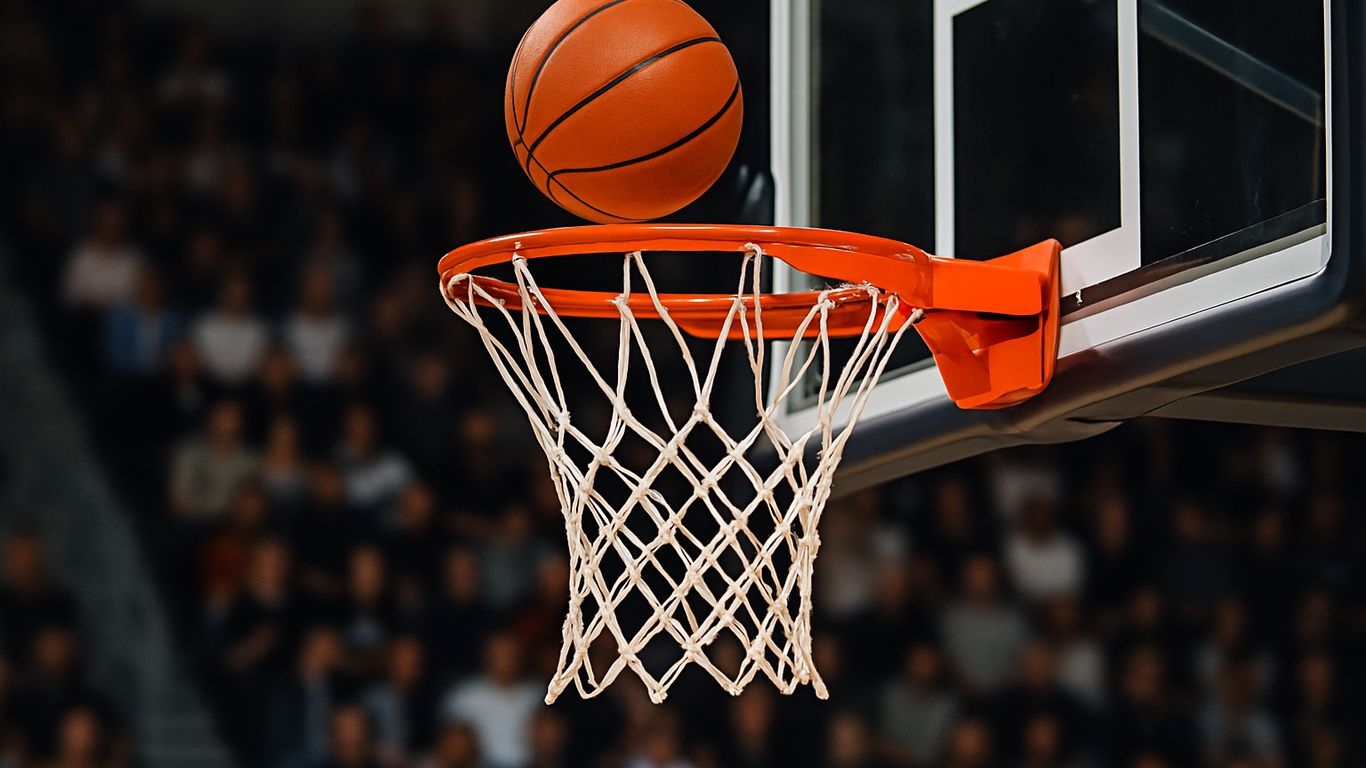 Basketball soaring towards the hoop in a crowded arena.