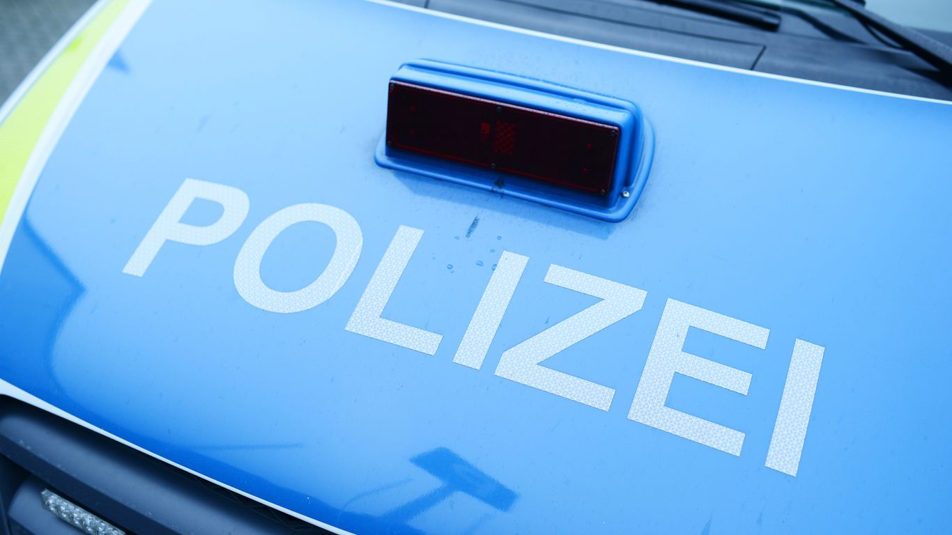 Blue police vehicle with visible "POLIZEI" text and light.